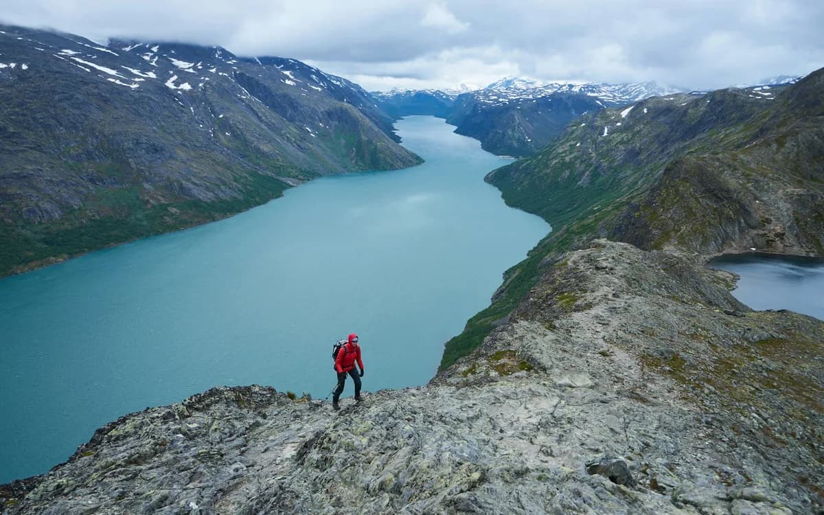 Solo hiker above an alpine lake