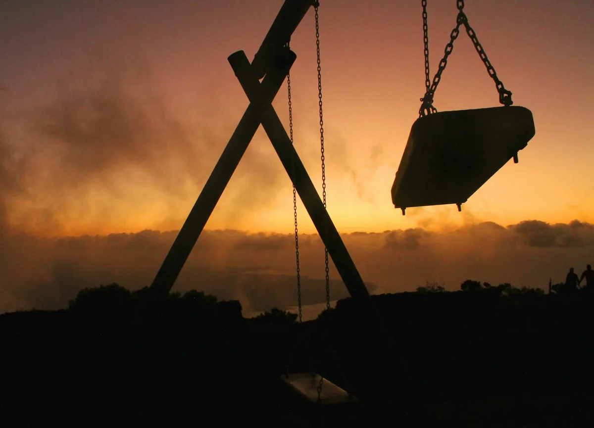 Empty swings in a park at dusk